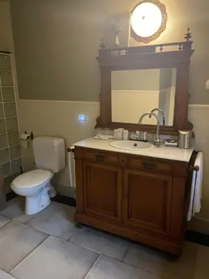 a bathroom with a toilet and a sink and a mirror at Sogni d oro in Peer