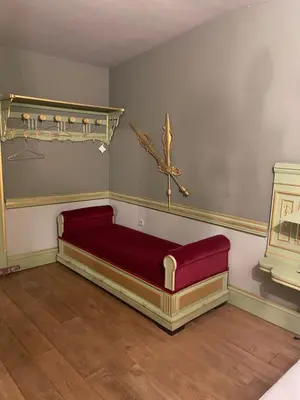 a bed in a room with a cross on the wall at Sogni d oro in Peer