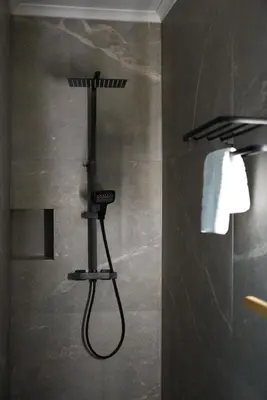 a shower with a shower head in a bathroom at Min Su in Waremme