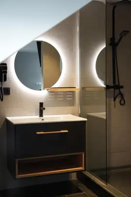 a bathroom with a sink and a mirror and a shower at Min Su in Waremme