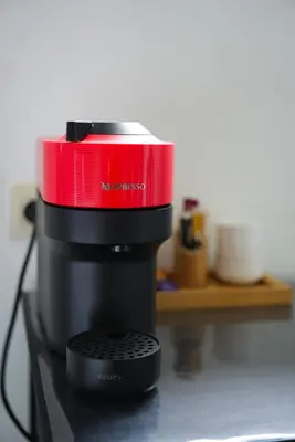 a red and black coffee maker sitting on a counter at Min Su in Waremme