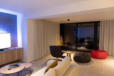 a living room with a couch and a television at Villa Armande in Zammelen