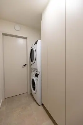 a laundry room with a washer and dryer next to a door at Villa Armande in Zammelen