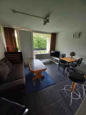 a living room with a couch and a table at Ap57 Nature Ardennes Economy class apartment in Kelmis