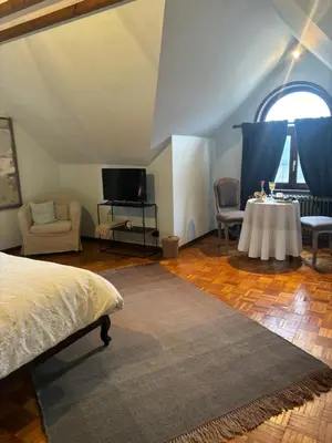 a bedroom with a bed and a table and chairs at Sophia Rooms 14 in Maasmechelen