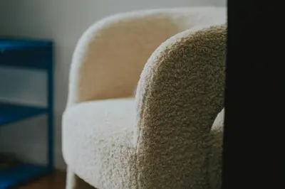 a white chair sitting next to a blue table at 2 bedroom apartment near the city center in Liège