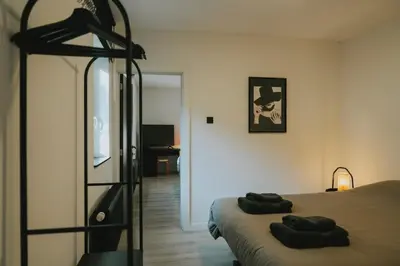 a bedroom with a bed with two towels on it at 2 bedroom apartment near the city center in Liège