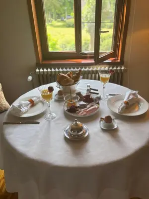 a white table with plates of food on it at Sophia Rooms 14 in Maasmechelen