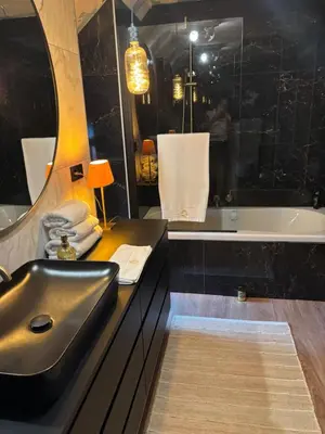 a bathroom with a sink and a bath tub at Sophia Rooms 14 in Maasmechelen