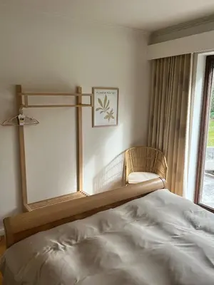 a bedroom with a large bed and a window at Ardilla - holiday house in an oasis of green in Heusden - Zolder