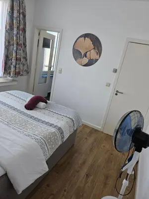 a bedroom with a bed with a stuffed animal on it at Phocas in Liège