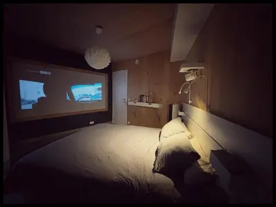 a bedroom with a bed and a tv on the wall at Appartement tout eco-confort proche du centre in Liège
