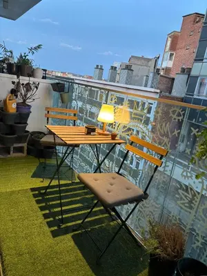 a table and two chairs on a balcony at Appartement tout eco-confort proche du centre in Liège