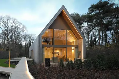 a small house with a glass facade at Lodge - 4 personen - Woodz Lodges in Heusden - Zolder