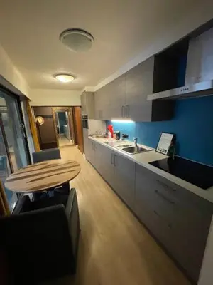 a kitchen with a table and a sink and a counter at mi casa naranja in Lommel