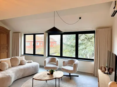 a living room with a couch and two chairs and a table at Hartje Borgloon in Borgloon