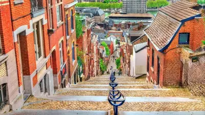 a view of an alley with stairs between buildings at LifeinLiege in Liège