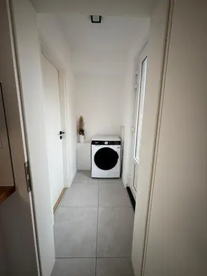 a small hallway with a black and white microwave at Appartement Hoang in Ans