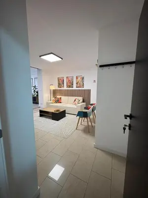 a living room with a couch and a table at Appartement Hoang in Ans