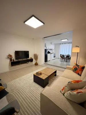 a living room with a couch and a table at Appartement Hoang in Ans