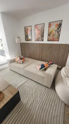 a bedroom with a bed with two pillows on it at Appartement Hoang in Ans