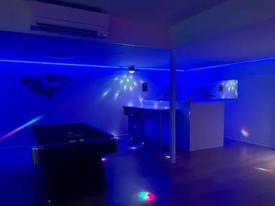 a dark room with a table and a blue light at Le Luxe in Fléron
