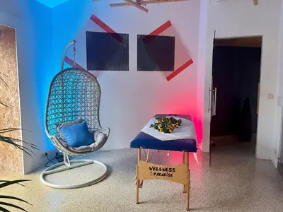 a room with a chair and a sign in front of a wall at Le Rêve de Narcisse in Fléron