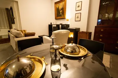 a dining room table with two silver dishes on it at 