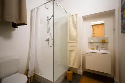 a bathroom with a shower and a toilet and a sink at 