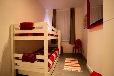 two bunk beds in a small room with a bedroom at 