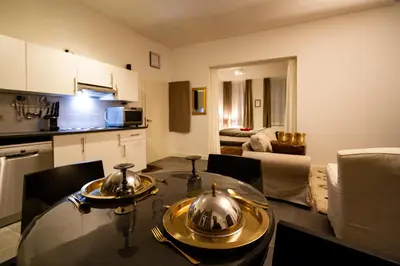 a kitchen and a dining room table with two tea pots on it at 