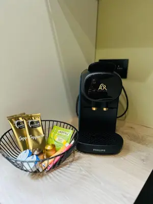 a basket of candy and a toaster on a table at Élégant appartement avec bain balnéothérapie in Liège