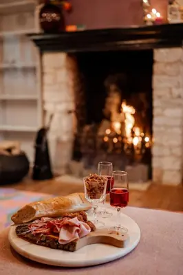 a plate of food and two glasses of wine at Sfeervolle B&B in de Voerstreek Lo-Ghis - met Zwembad in Voeren