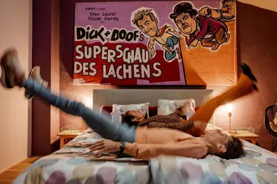 two people laying on a bed with their arms in the air at Sfeervolle B&B in de Voerstreek Lo-Ghis - met Zwembad in Voeren