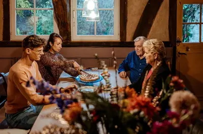 a group of people sitting around a table at Sfeervolle B&B in de Voerstreek Lo-Ghis - met Zwembad in Voeren