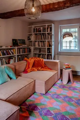 a living room with a couch and a rug at Sfeervolle B&B in de Voerstreek Lo-Ghis - met Zwembad in Voeren