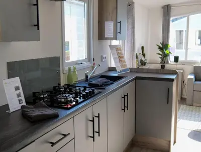 a kitchen with a stove and a counter top at Camping Zavelbos Superior Chalet in Maaseik