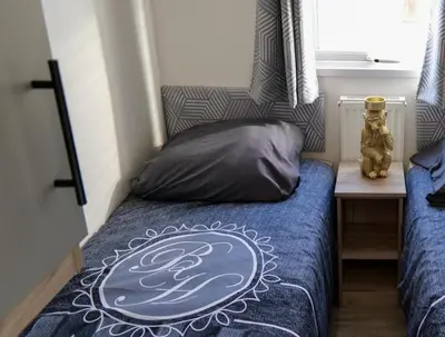 a bedroom with a bed with a pillow on it at Camping Zavelbos Superior Chalet in Maaseik