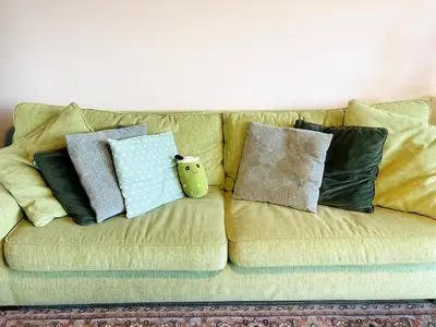 a couch with pillows on top of it at Sweet Valley Cozy in Zutendaal