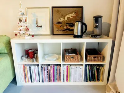 a white book shelf filled with books at Sweet Valley Cozy in Zutendaal