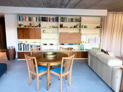 a dining room with a table and a couch at Sweet Valley Cozy in Zutendaal