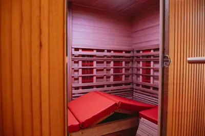 a walk in closet with red cushions on the shelves at Art'lette Loft Balneo Bath & Infrared Sauna in Herve