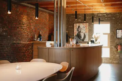 a bar in a restaurant with a brick wall at Art'lette Loft Balneo Bath & Infrared Sauna in Herve
