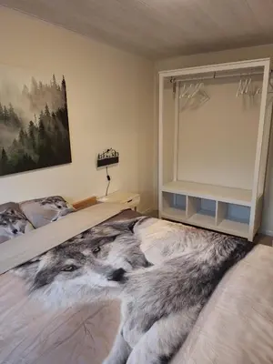 a bedroom with a bed with a wolf blanket at Sakurahuisje in Lanaken