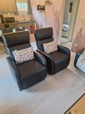 two leather chairs sitting next to each other in a salon at Sakurahuisje in Lanaken