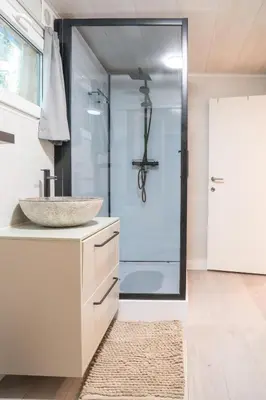 a bathroom with a sink and a shower at Sakurahuisje in Lanaken