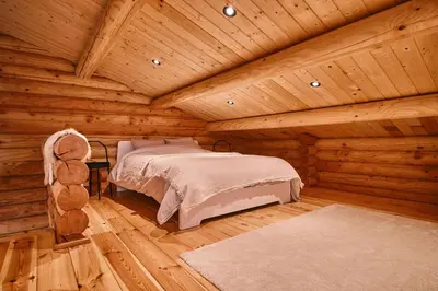 a bedroom with a bed in a log cabin at Le chalet Nord in Verviers