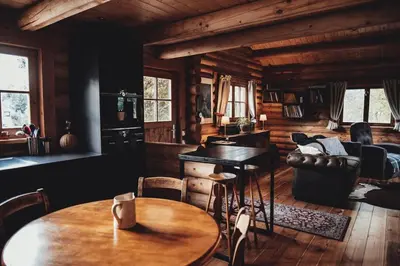 a living room with a table and a couch at Le chalet Nord in Verviers