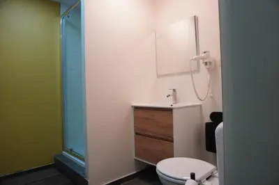 a bathroom with a sink and a toilet and a shower at SpaNChill in Herstal