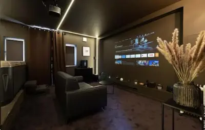 a living room with a couch and a tv at Spa&Chill in Seraing